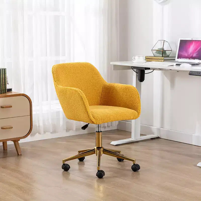 Questa sedia girevole da ufficio è regolabile in altezza, ha le ruote, le gambe placcate in oro e la base cromata.